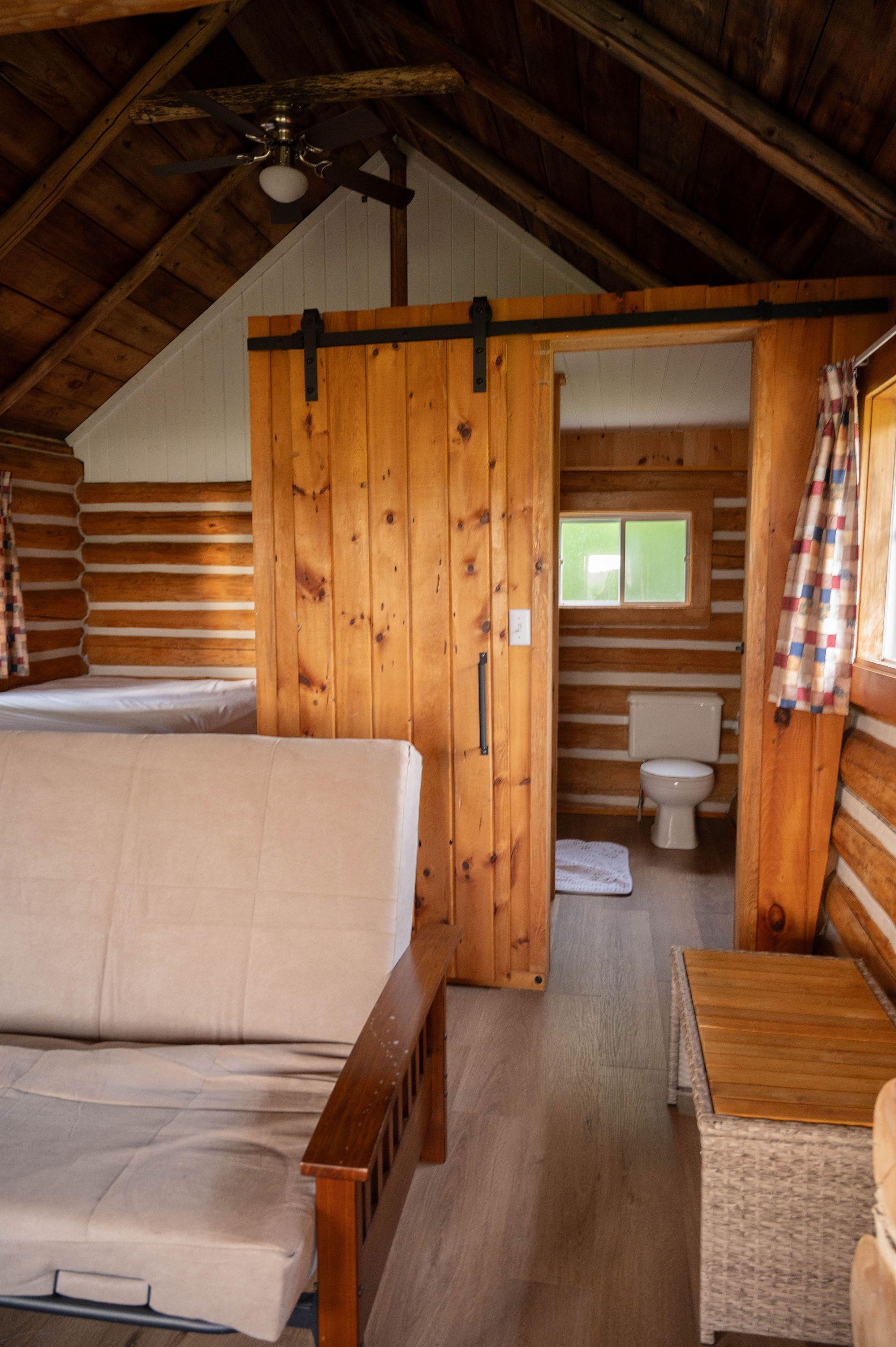 Living room with log walls and view of the lake